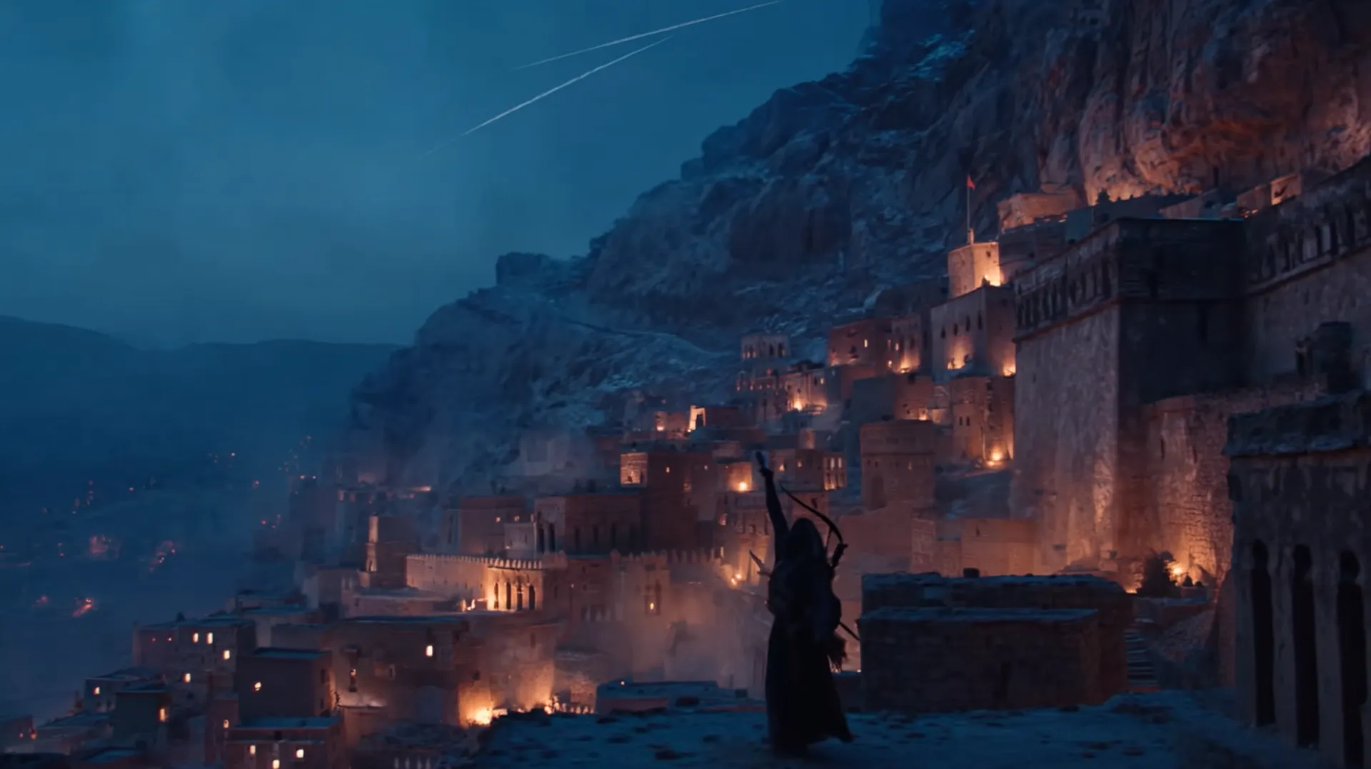 Predawn view of an ancient mountainside city with sandstone terraces, a lone silhouette on a rooftop calling to prayer as faint light breaks on the horizon